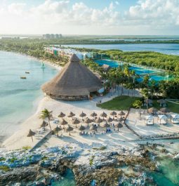 cancun all inclusive resort with palapa and beach chairs