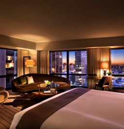 Sleek and moody hotel room with subtle lighting and city views