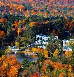 lakefront resort surrounded by fall foliage