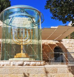Large gold menorah in glass case in Jerusalem
