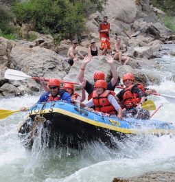 people whitewater rafting in boat