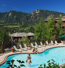 Mountains tower over a resort pool in Colorado