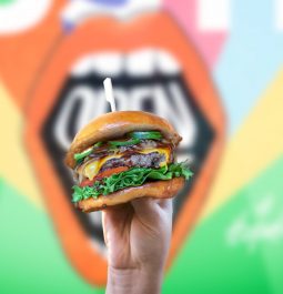 burger with colorful mural in backdrop