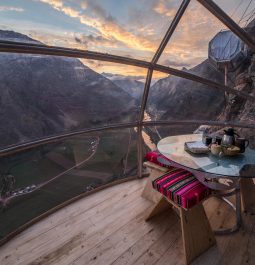 Glass dome hotel suite hanging off side of cliff