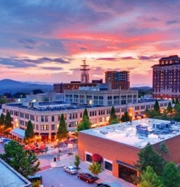 Downtown of Asheville with brick buildings and mountains in distance