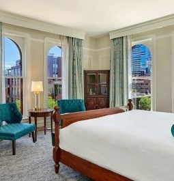 hotel room with teal accent colors and views of denver city