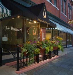 exterior of restaurant with large window with flower box and awning