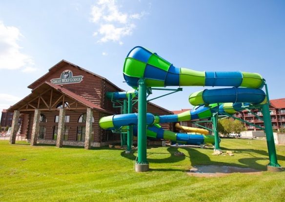 Lodge with twisty green and blue water slide sitting next to it