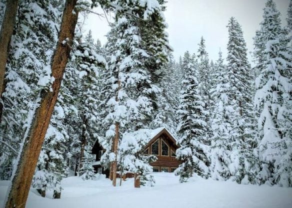 log cabin home in the snow