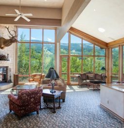 living room with floor to ceiling windows looking out on mountains