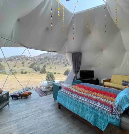 bed inside of a dome tent