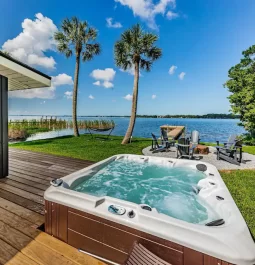 backyard with hot tub and lake views