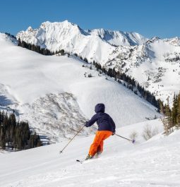 Skier with print orange pants going down the mountain