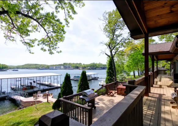 deck overlooking a lawn and lake