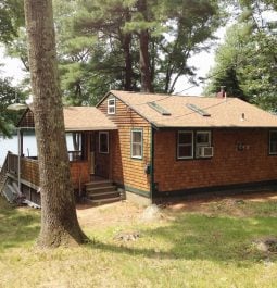Exterior of home and yard with lake in background
