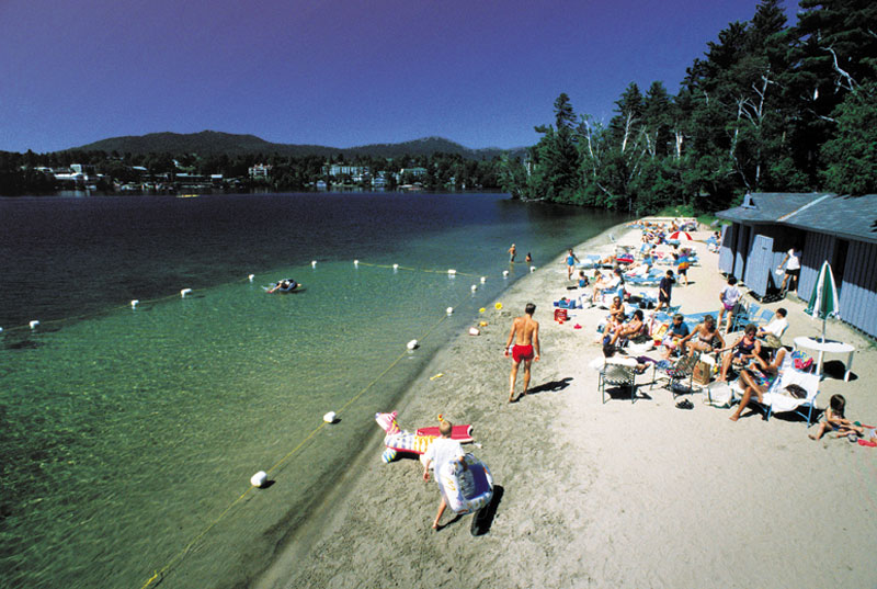 An aerial view of a private beach on Mirror Lake near the Crowne Plaza Lake Placid Resort