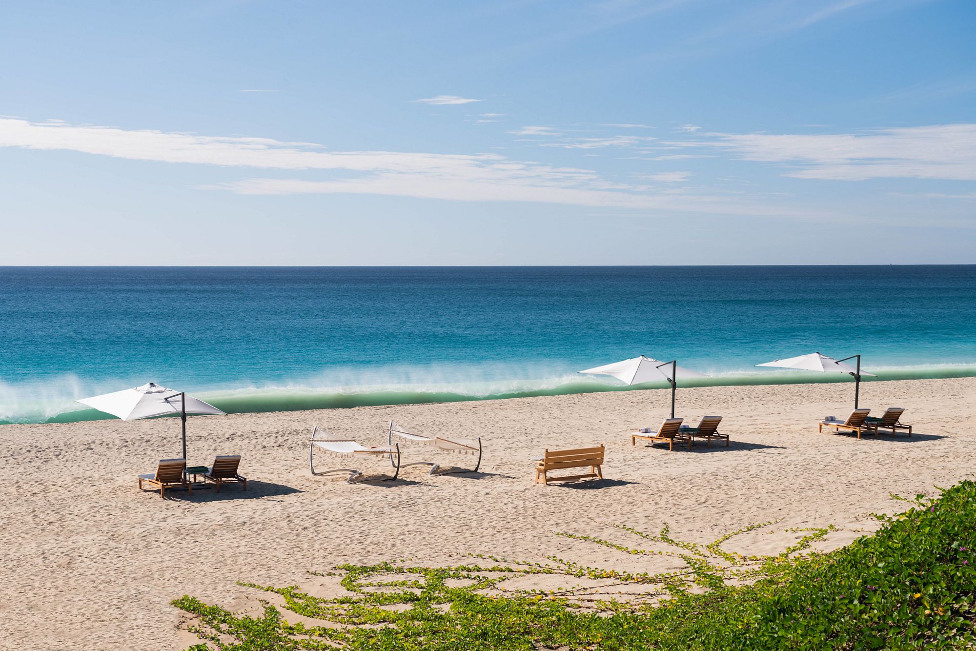 Beach chairs in front of a blue Caribbean sea at Ritz-Carlton Turks & Caicos