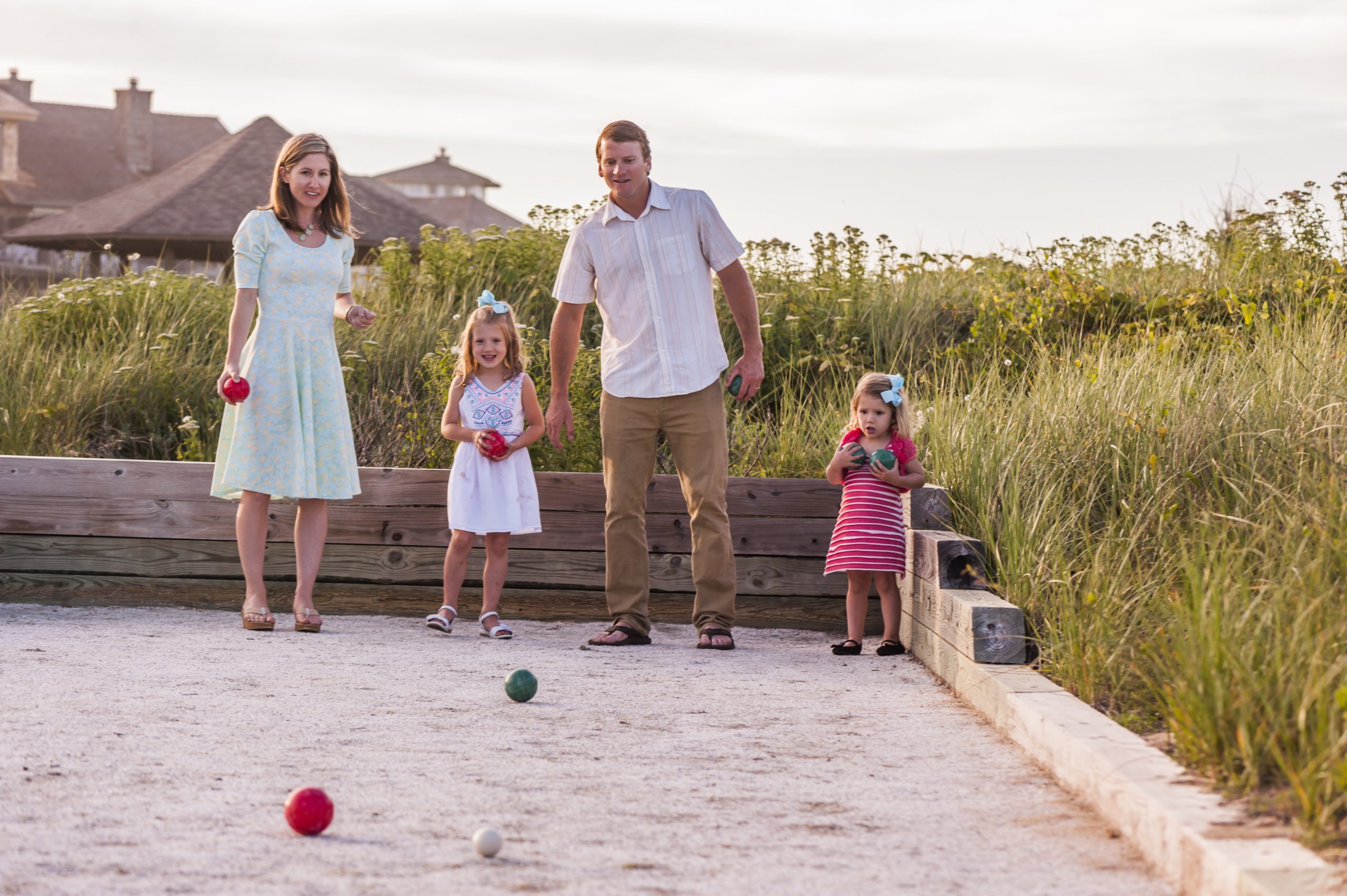 Family playing bocce ball at the resort