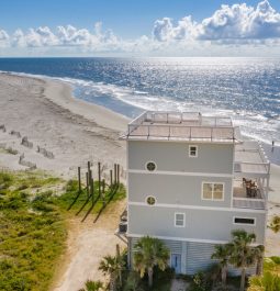 Aerial view of a stand-alone beach house with ocean views from every angle