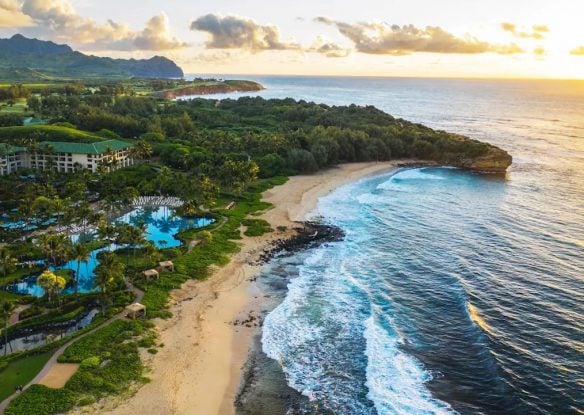aerial view of Hawaiian coastline with beachfront resort in view