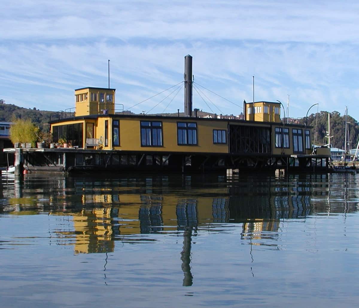 A historic yellow ferryboat sits in the harbor in Sausalito, California