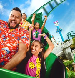 Family smiling while riding roller coaster at LEGOLAND Florida