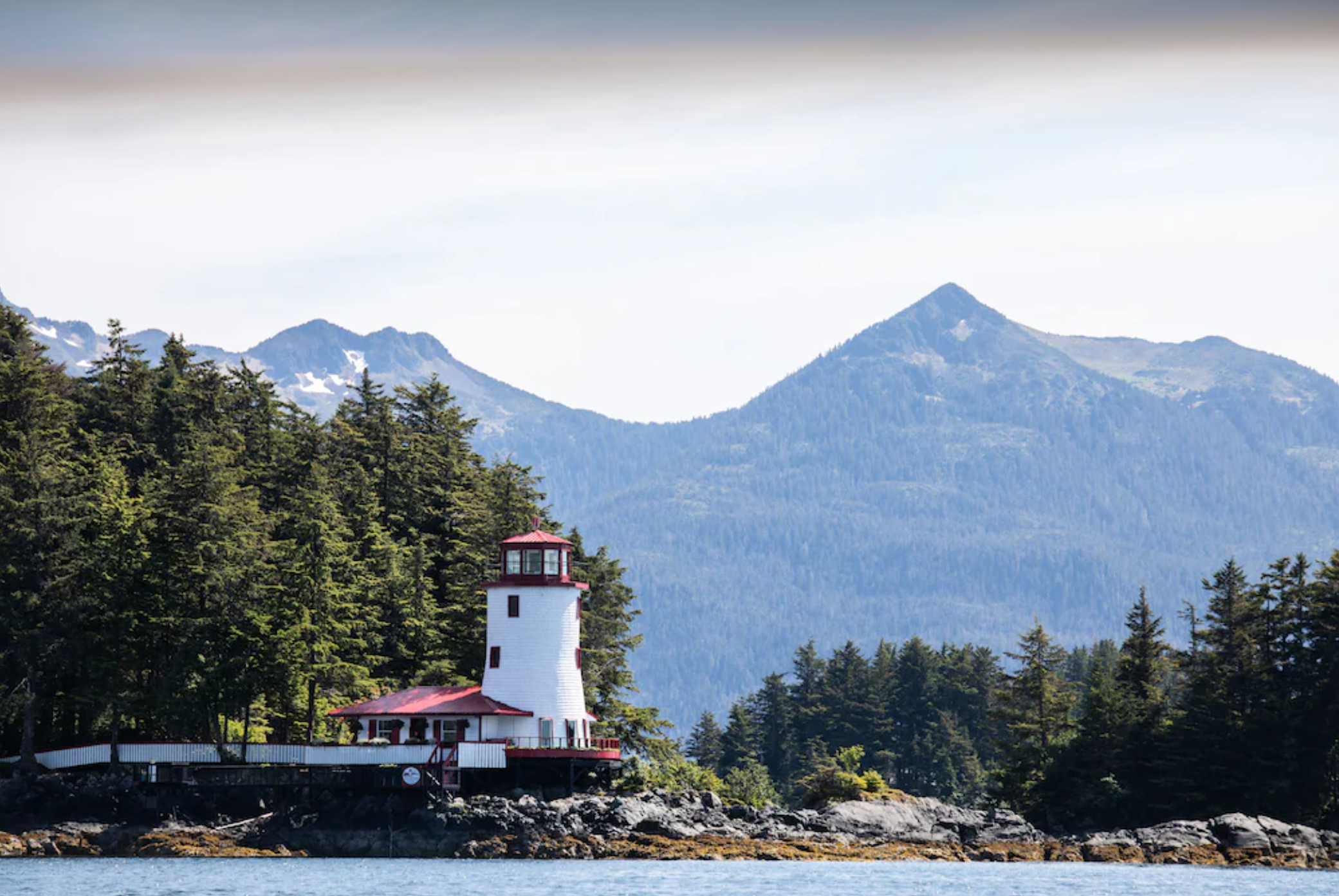 red and white lighthouse on an island in Sitka