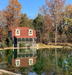 An adorable cottage sits waterside by a private pond in West Virginia
