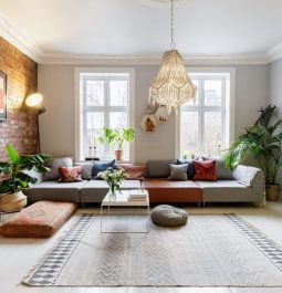 Living room with bohemian accent decor, a brick wall and a neon yellow door