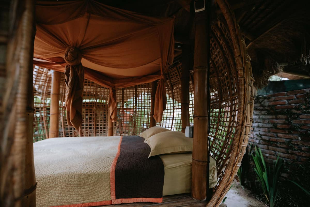 Bed with a bamboo birdnest-like canopy 
