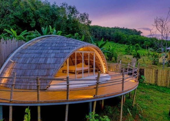 Spaceship-esque cocoon on stilts with a sunset backdrop