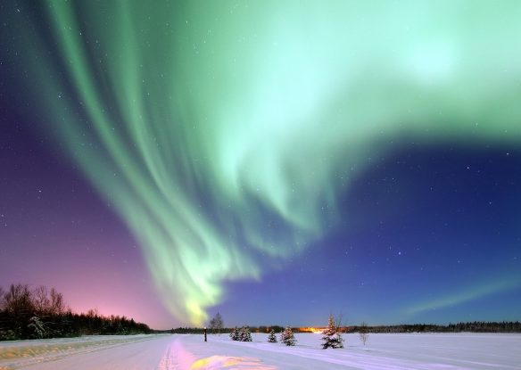 northern lights over a snowy landscape