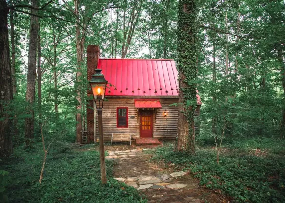 Cabin with red roof in woods