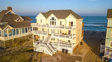 Aerial view of large beach house and water