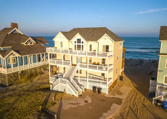 Aerial view of large beach house and water