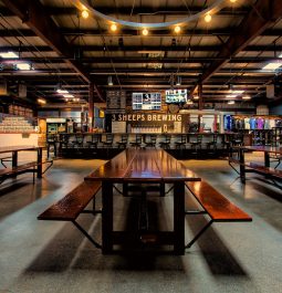 spacious brewery with long tables and wood tones