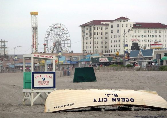 kayak and lifeguard stand on beach with hotel behind