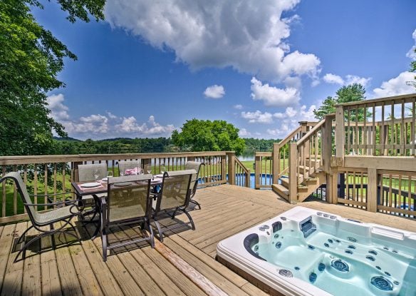 Lake house decking with table and hot tub