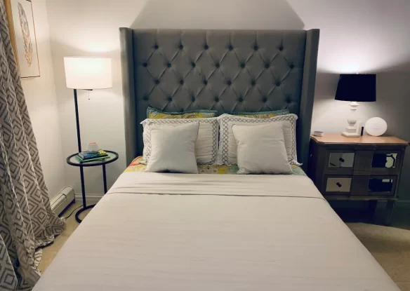 Bed with pillows and lamps on both sides of the bed