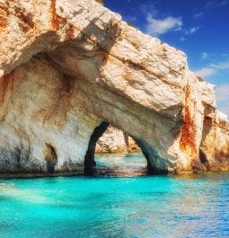 rock arch formations in a brilliant blue sea