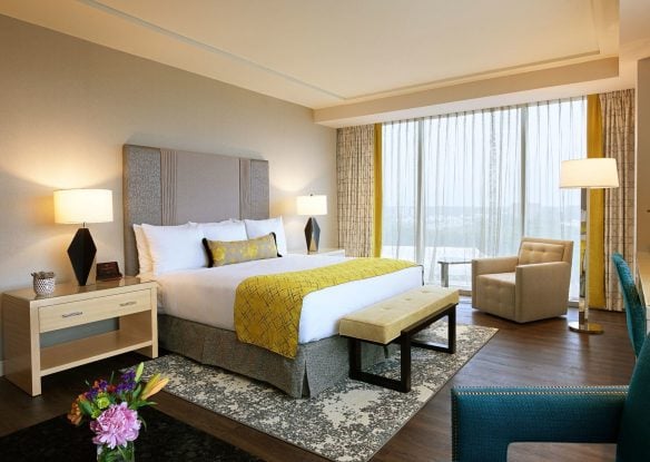 A bright hotel room with king bed