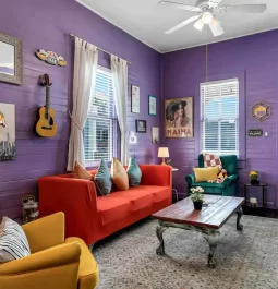 Purple walls and red couch in living room