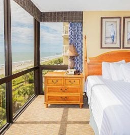 Hotel room with big panoramic windows and an ocean view
