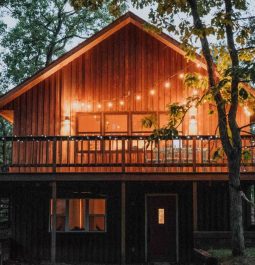 exterior of cabin lit up with fairy lights