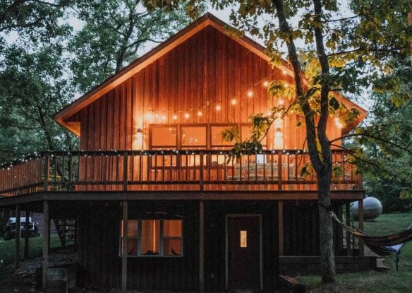 exterior of cabin lit up with fairy lights