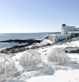 igloo tables with snow overlooking the ocean