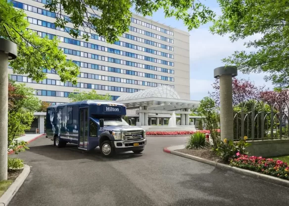 airport shuttle bus parked in front of a hotel
