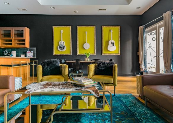 Dark toned open plan room with pops of vibrant color