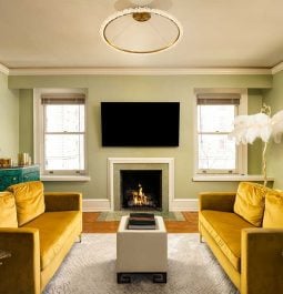 living room with two yellow couches facing each other and a fireplace