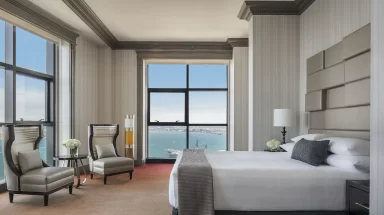 Hotel suite with panoramic windows overlooking San Diego Bay